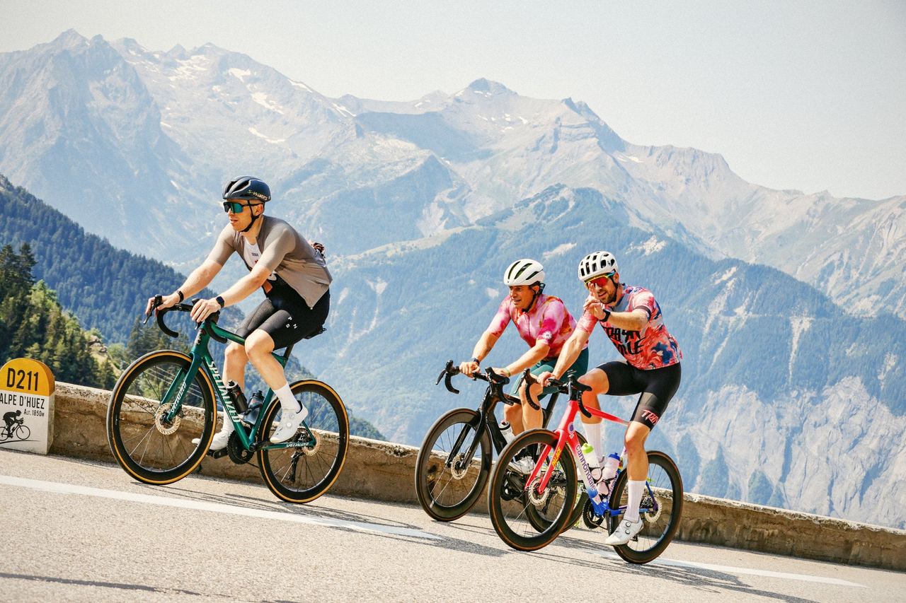 Siôn, centre in a pink jersey, riding up Alpe d’Huez with two friends